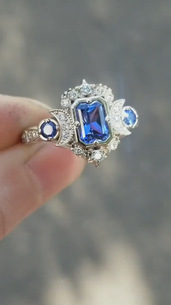 Load and play video in Gallery viewer, Radiant Blue Sapphire Selene Crescent Moon Engagement Ring - Diamonds and Blue Chatham Sapphires - 14k Palladium White Gold
