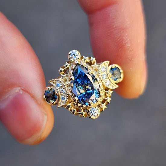 Load image into Gallery viewer, 14k gold pear cut moissanite blue sapphire engagement ring triple moon goddess stardust handmade wedding bridal ring
