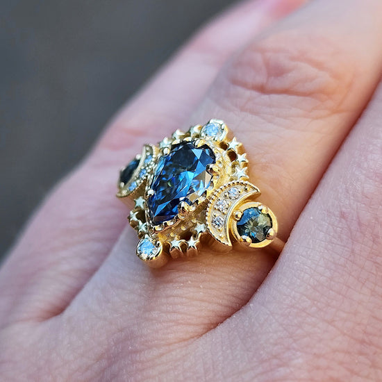 Load image into Gallery viewer, 14k gold pear cut moissanite blue sapphire engagement ring triple moon goddess stardust handmade wedding bridal ring
