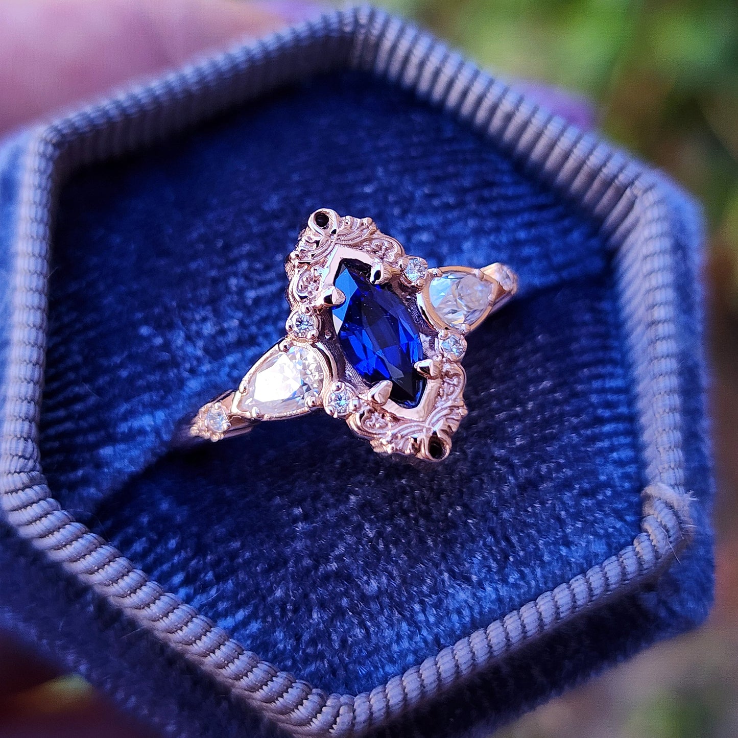Rose gold filigree ring with a blue sapphire marquise gemstone in a blue velvet box image 4