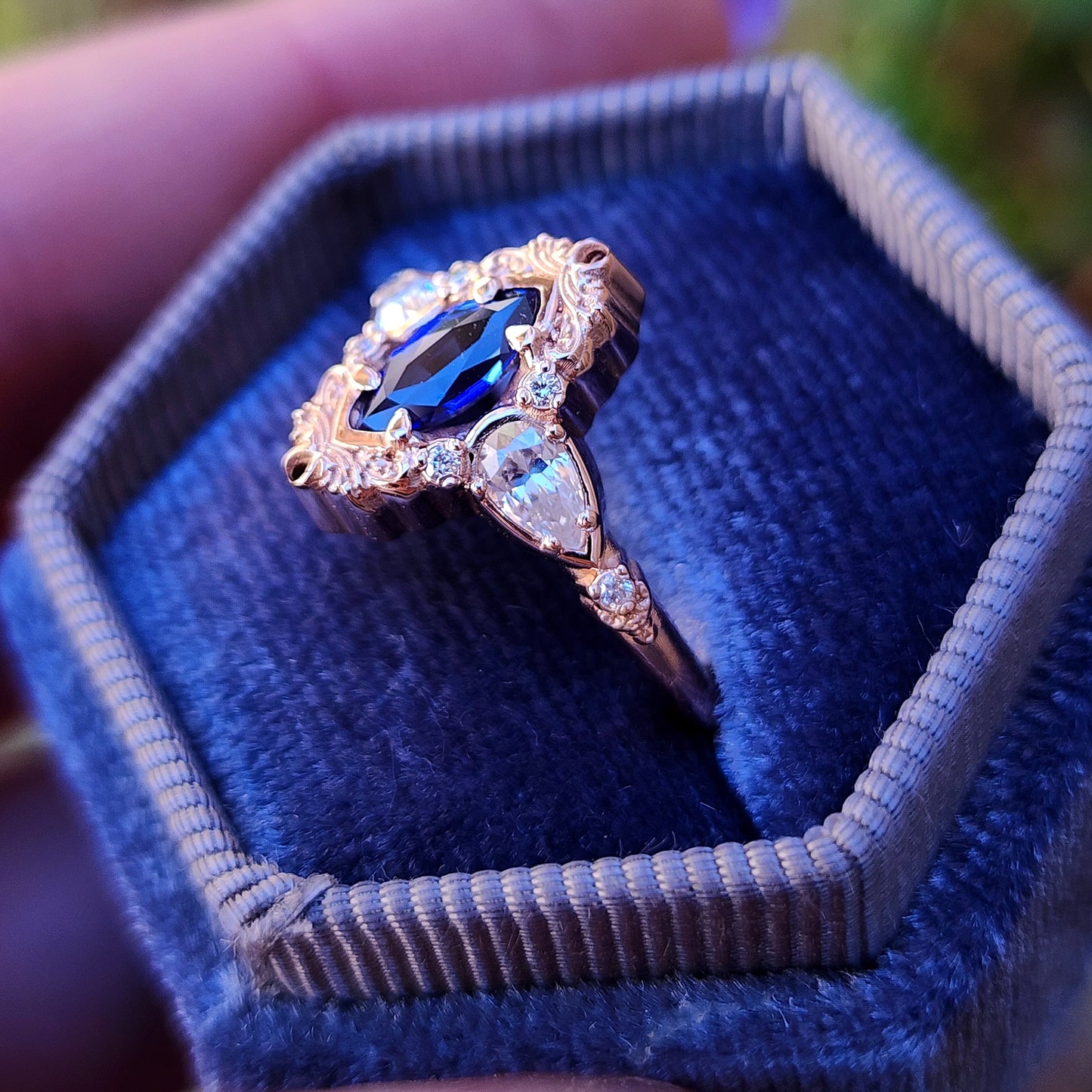 Rose gold filigree ring with a blue sapphire marquise gemstone in a blue velvet box image 5