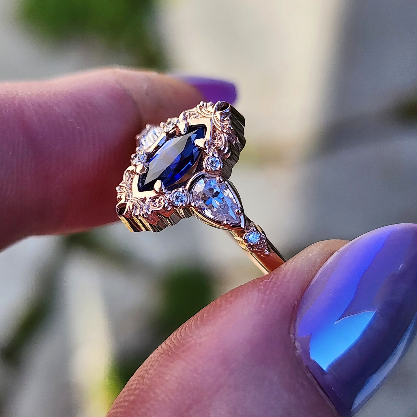 Rose gold filigree ring with a blue sapphire marquise gemstone in a blue velvet box image 8