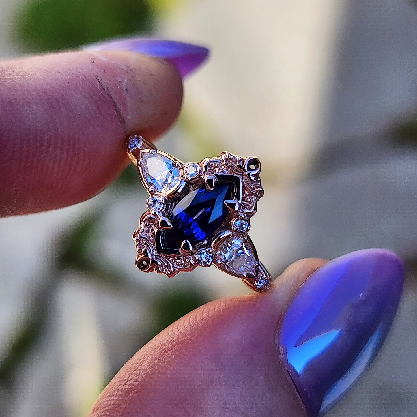 Rose gold filigree ring with a blue sapphire marquise gemstone in a blue velvet box image 7