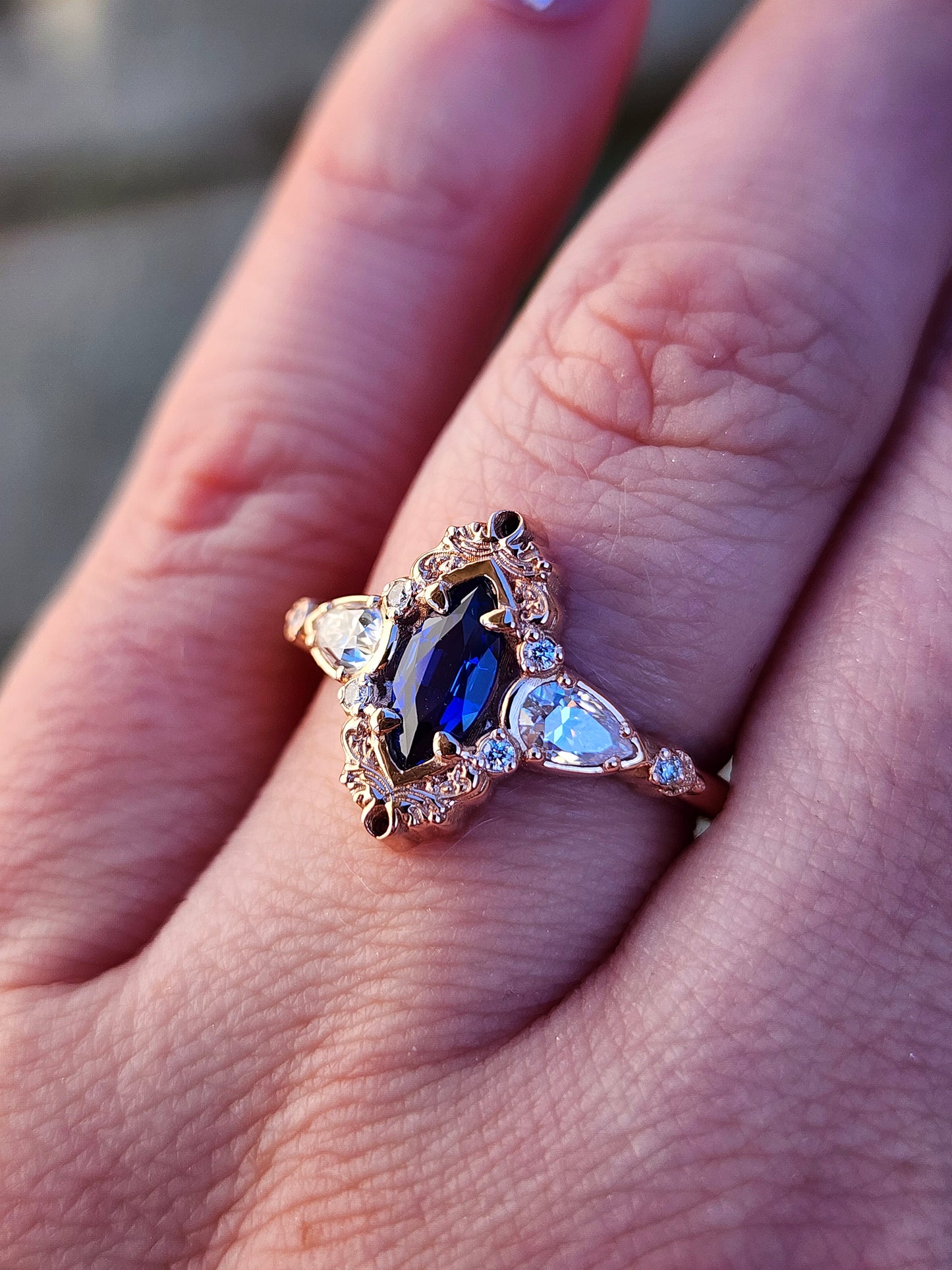 Rose gold filigree ring with a blue sapphire marquise gemstone in a blue velvet box image 10