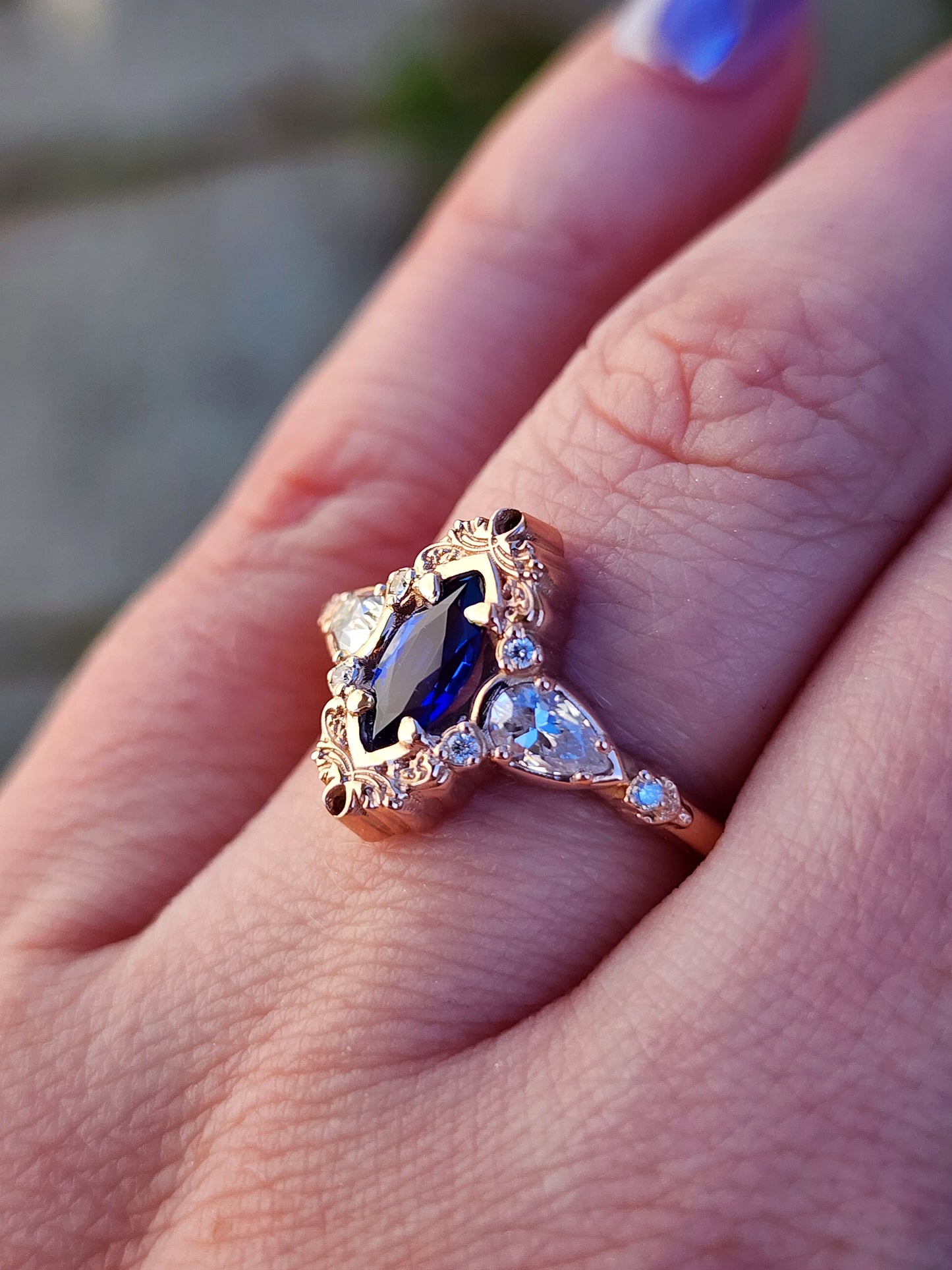 Rose gold filigree ring with a blue sapphire marquise gemstone in a blue velvet box image 11