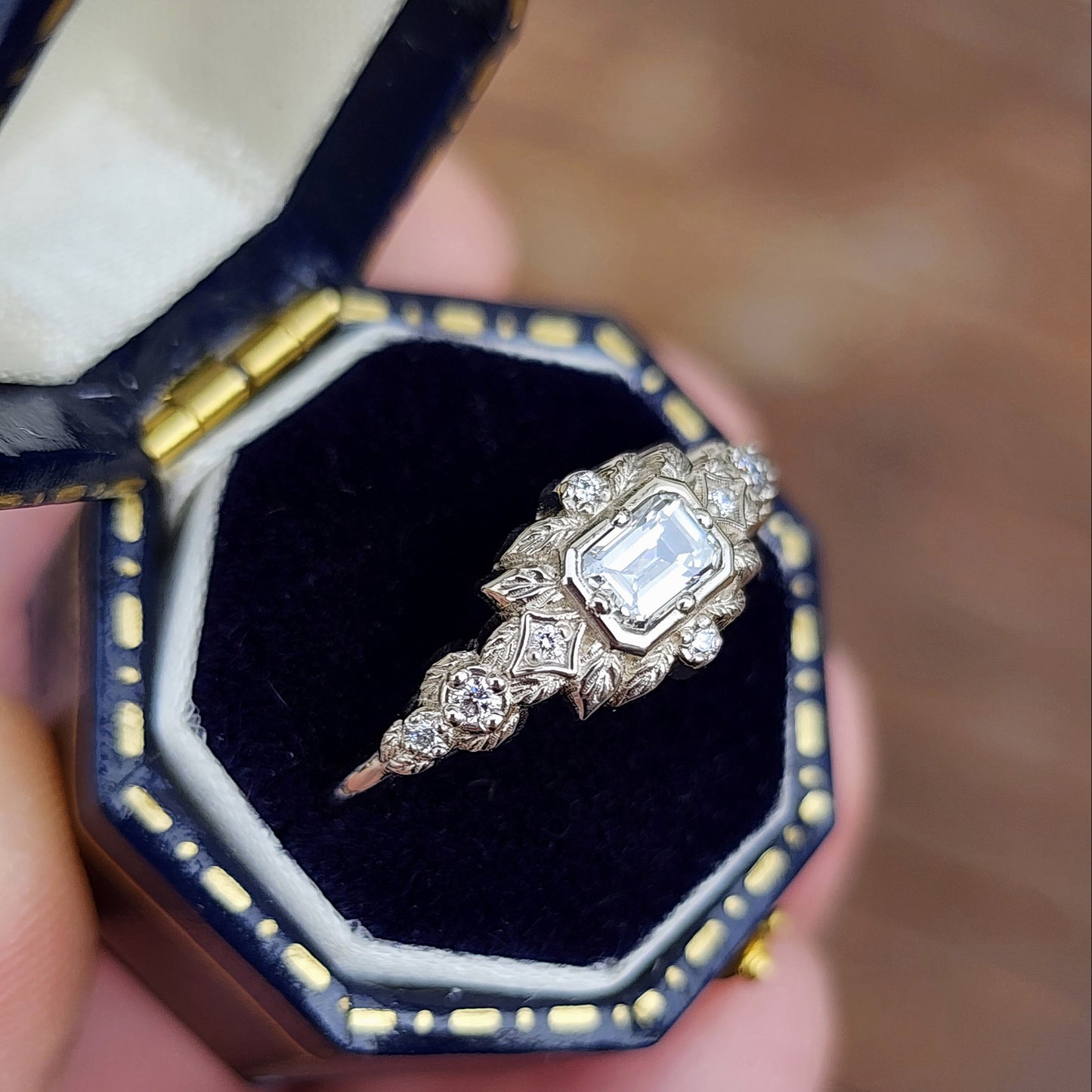 nature-inspired ring , featuring a .32 carat natural emerald-cut diamond set in an east-west orientation. The delicate leaf motif is crafted in 14kt palladium white gold image 6