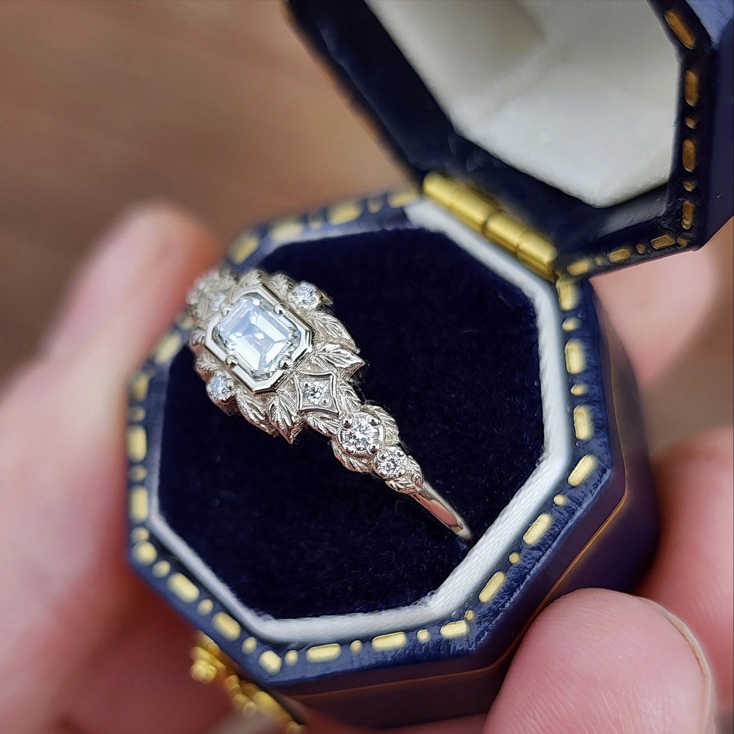 nature-inspired ring , featuring a .32 carat natural emerald-cut diamond set in an east-west orientation. The delicate leaf motif is crafted in 14kt palladium white gold image 5