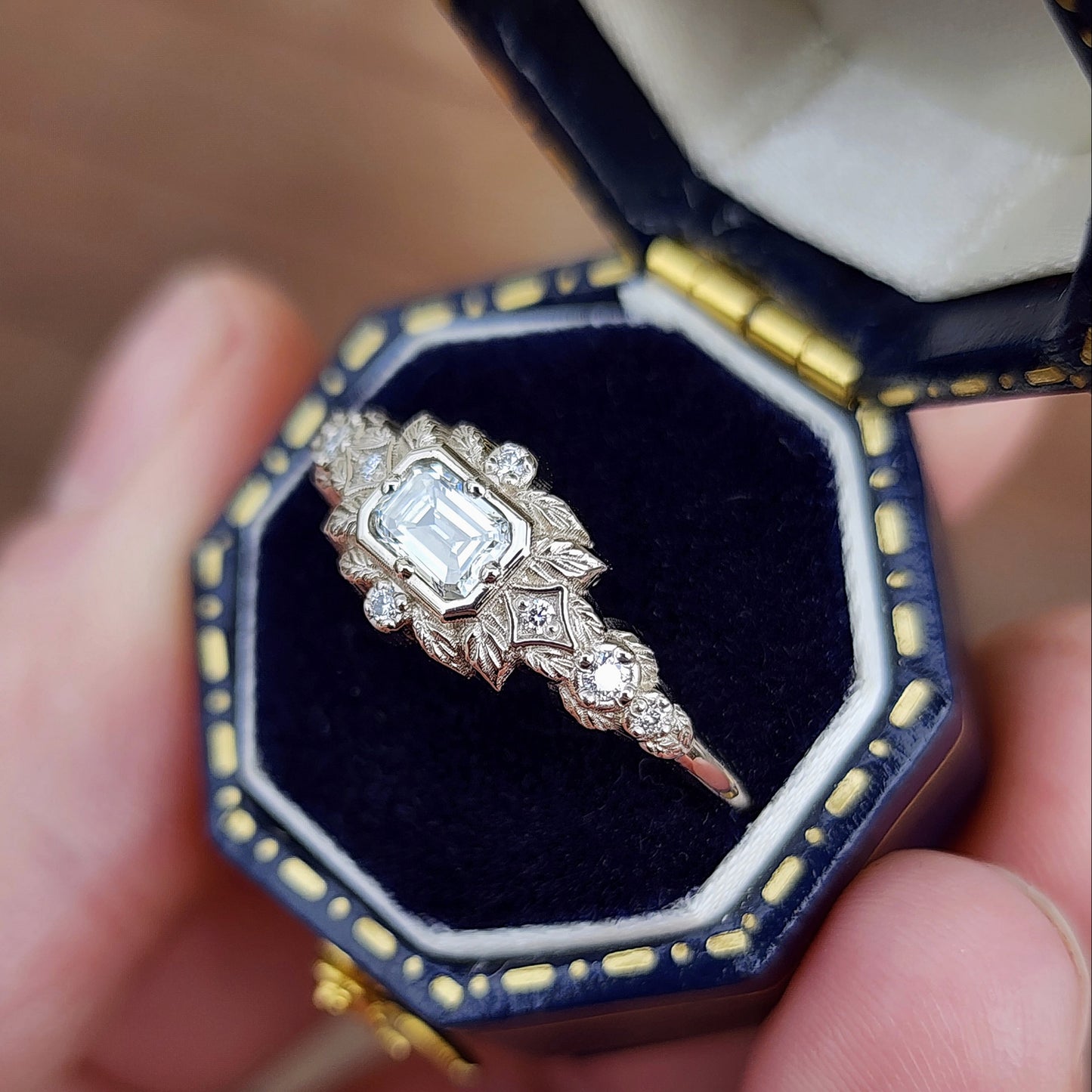 nature-inspired ring , featuring a .32 carat natural emerald-cut diamond set in an east-west orientation. The delicate leaf motif is crafted in 14kt palladium white gold image 4