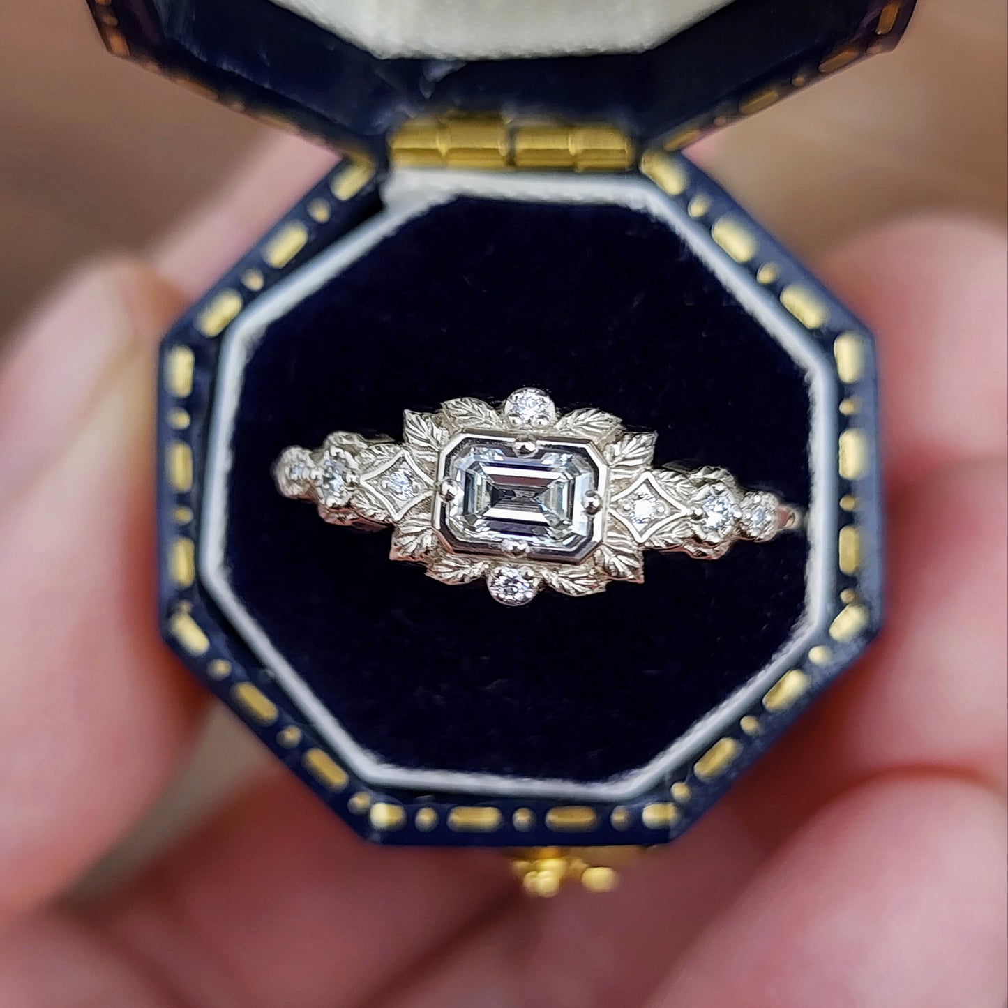 nature-inspired ring , featuring a .32 carat natural emerald-cut diamond set in an east-west orientation. The delicate leaf motif is crafted in 14kt palladium white gold image 3