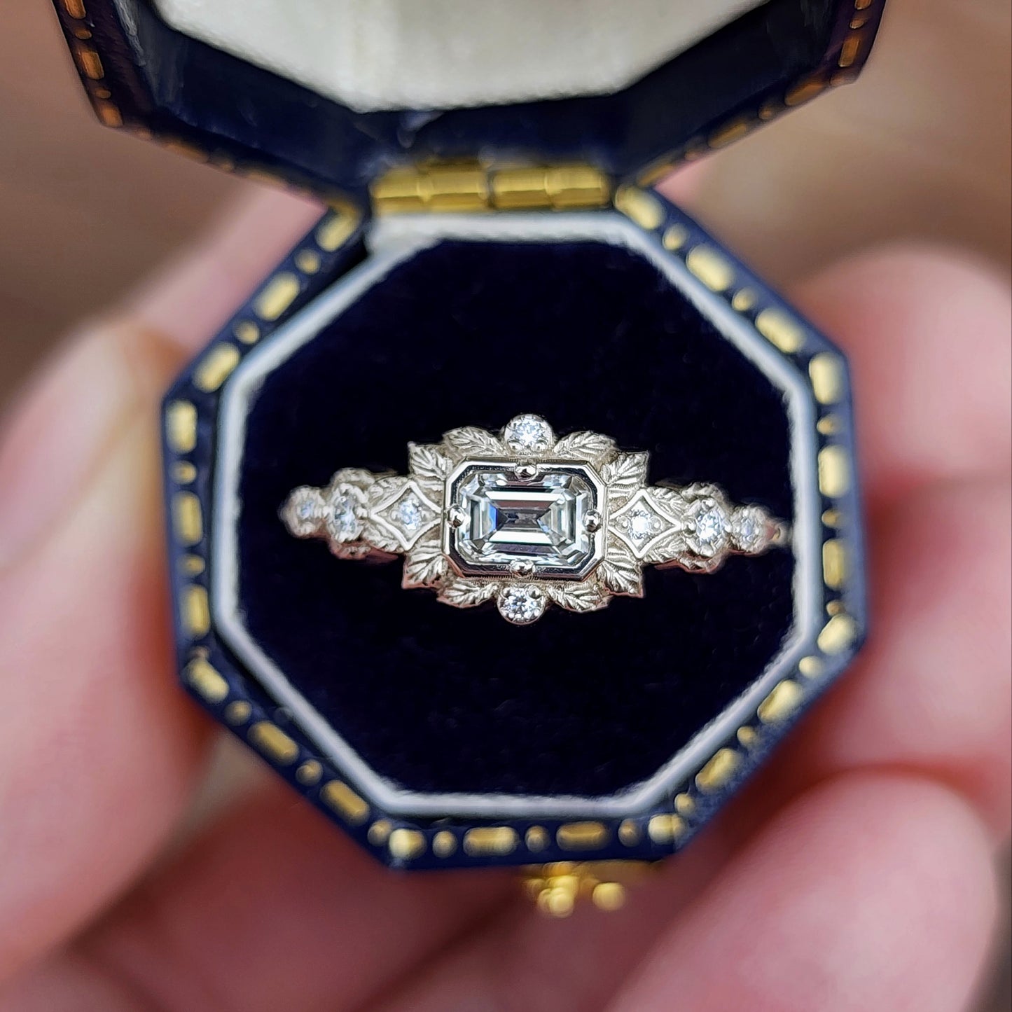 nature-inspired ring , featuring a .32 carat natural emerald-cut diamond set in an east-west orientation. The delicate leaf motif is crafted in 14kt palladium white gold image 1