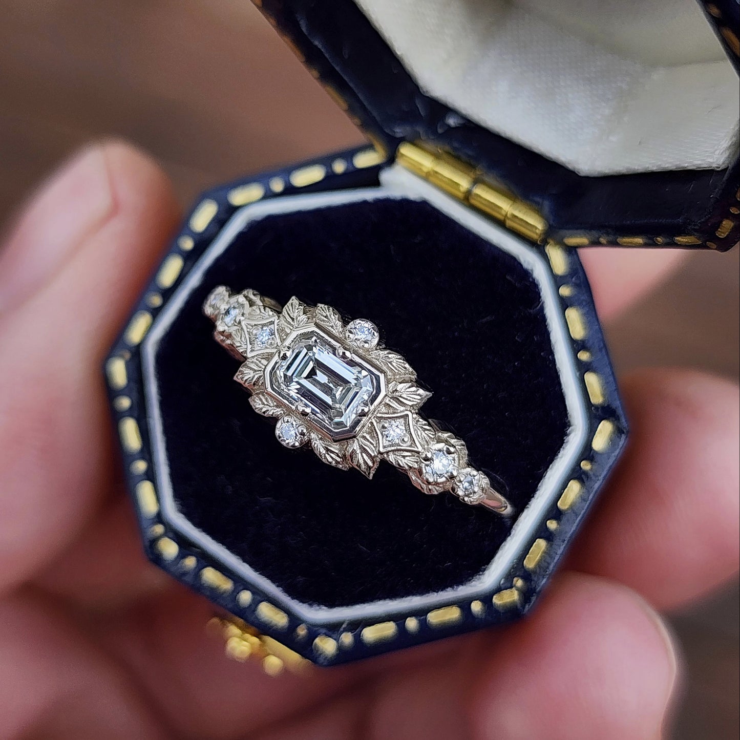 nature-inspired ring , featuring a .32 carat natural emerald-cut diamond set in an east-west orientation. The delicate leaf motif is crafted in 14kt palladium white gold image 2