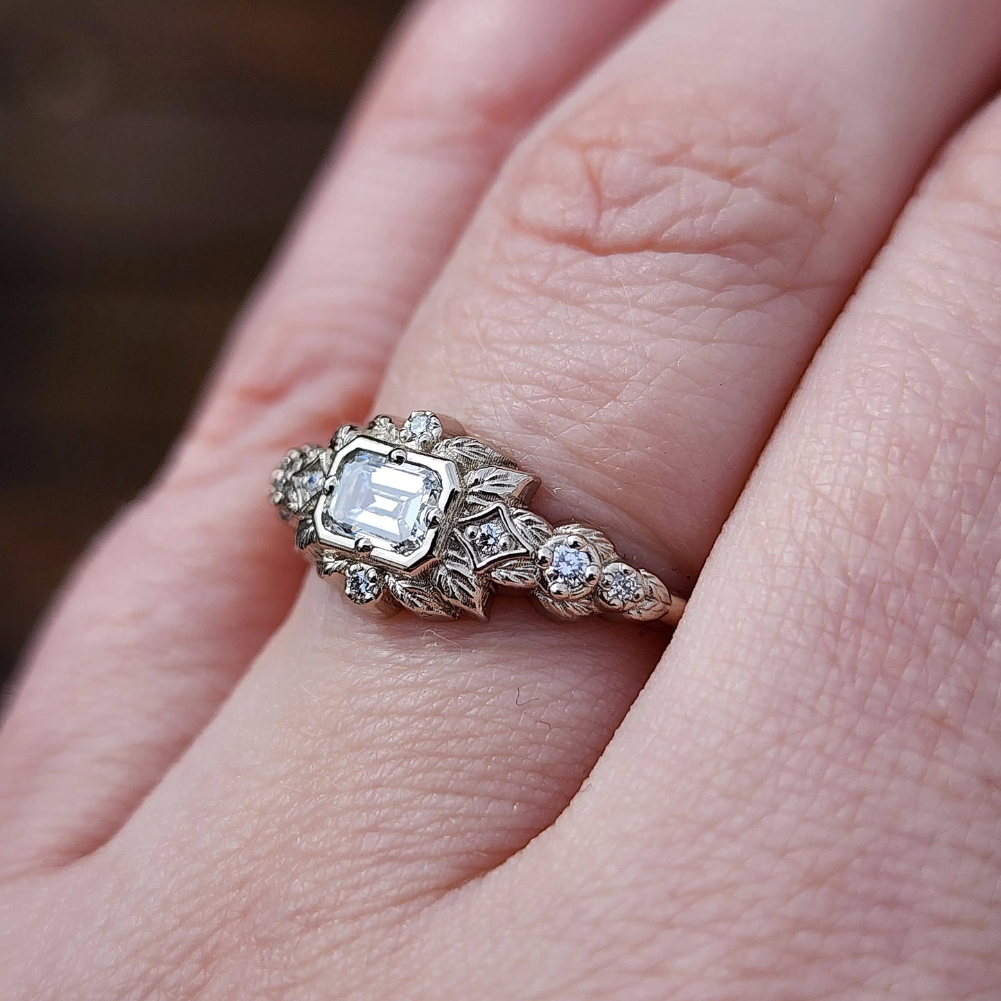 nature-inspired ring , featuring a .32 carat natural emerald-cut diamond set in an east-west orientation. The delicate leaf motif is crafted in 14kt palladium white gold image 8