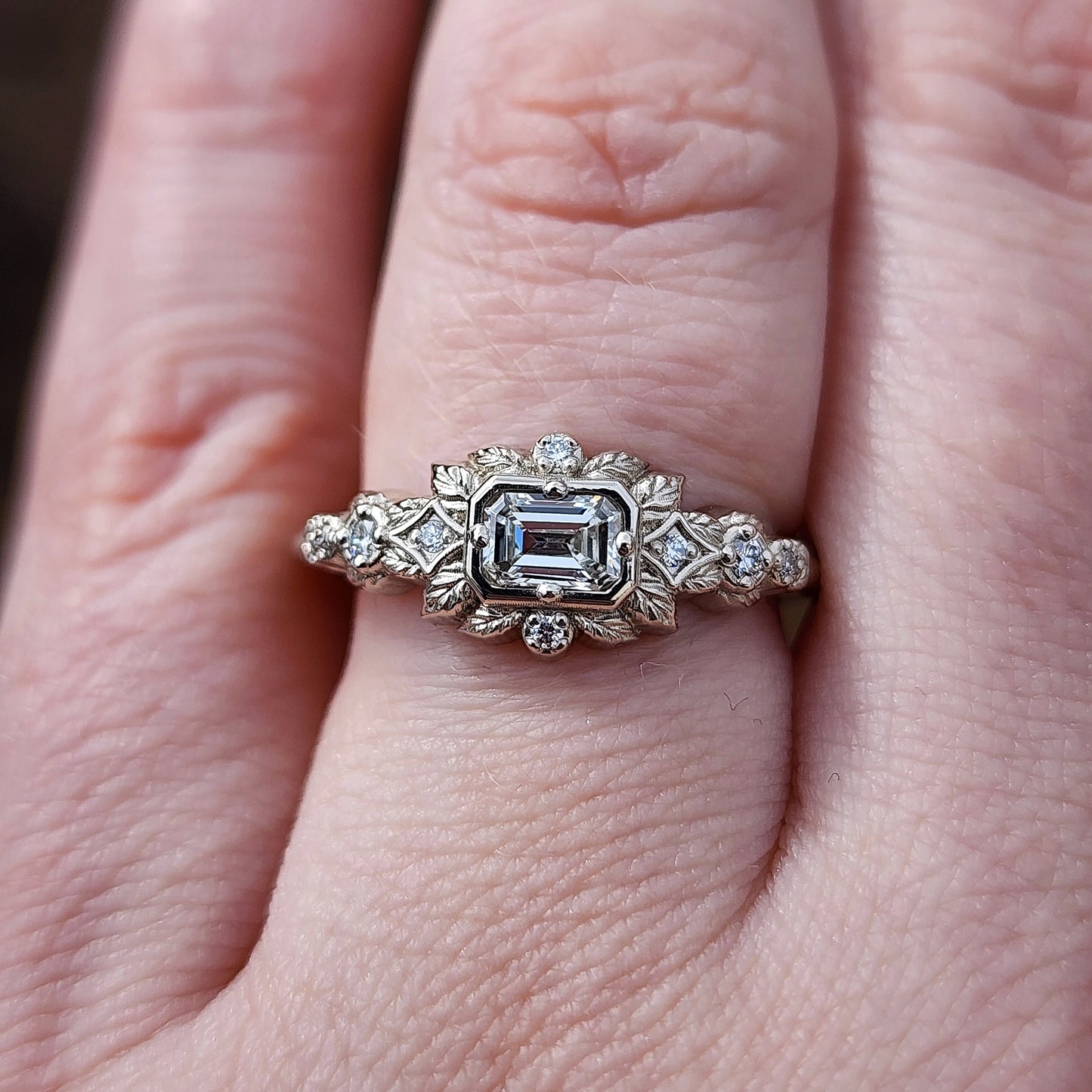 nature-inspired ring , featuring a .32 carat natural emerald-cut diamond set in an east-west orientation. The delicate leaf motif is crafted in 14kt palladium white gold image 7