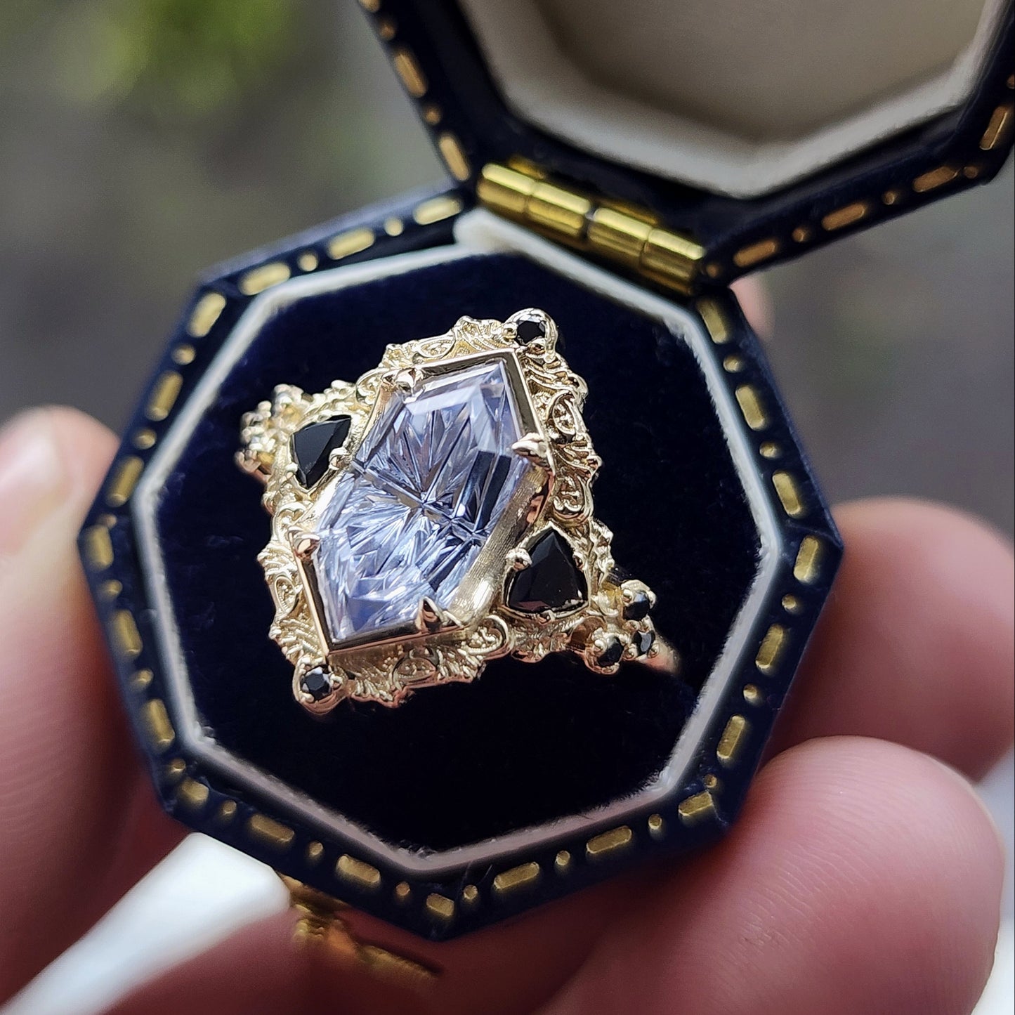 Ophelia/Delilah hybrid ring features a 2.92ct Light Purple Lab Sapphire Fantasy Cut from Fellowship Forge. The ring is accented with black diamond trillions totaling .18cts and additional black diamond accent stones totaling .07cts Crafted in 14kt yellow gold image 4