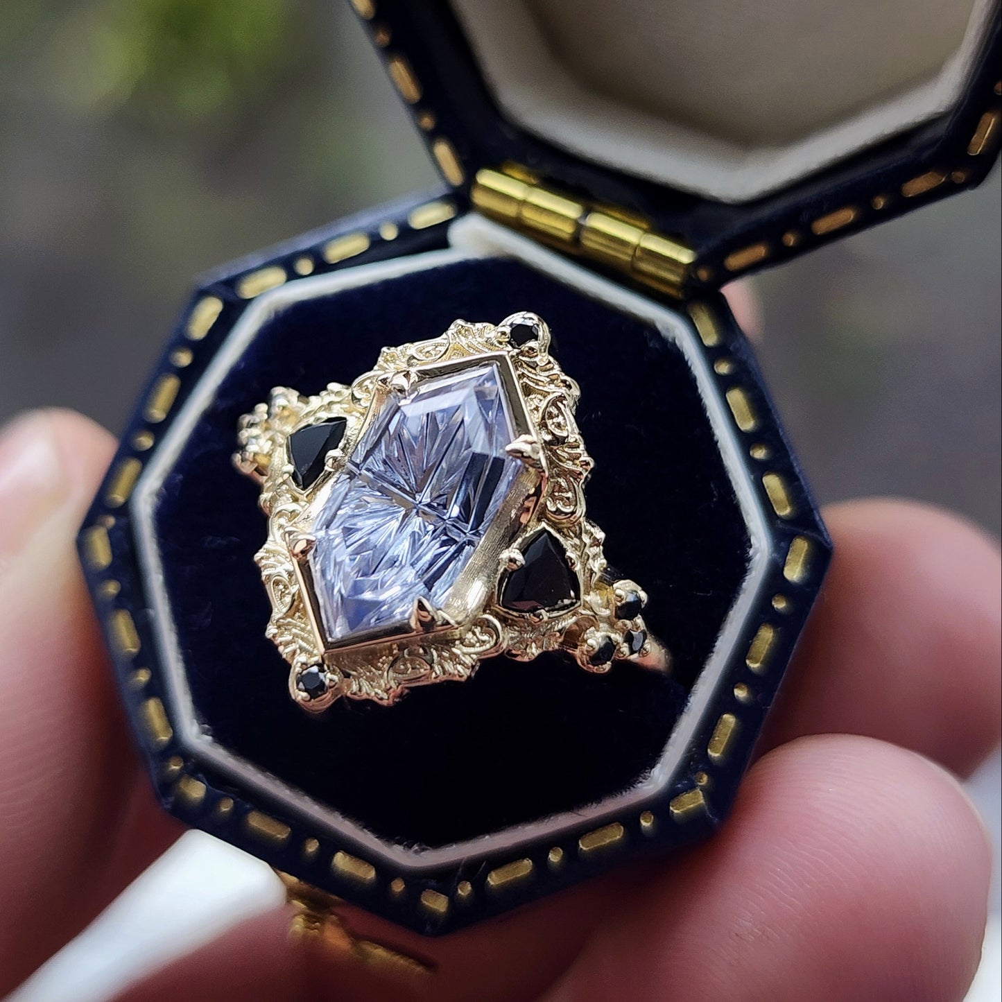 Ophelia/Delilah hybrid ring features a 2.92ct Light Purple Lab Sapphire Duchess Fantasy Cut from Fellowship Forge. The ring is accented with black diamond trillions totaling .18cts and additional black diamond accent stones totaling .07cts Crafted in 14kt yellow gold image 7