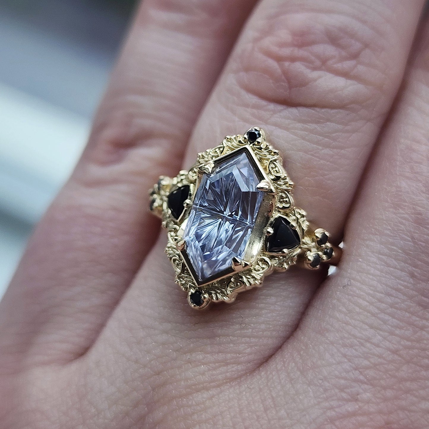 Ophelia/Delilah hybrid ring features a 2.92ct Light Purple Lab Sapphire Duchess Fantasy Cut from Fellowship Forge. The ring is accented with black diamond trillions totaling .18cts and additional black diamond accent stones totaling .07cts Crafted in 14kt yellow gold image 9