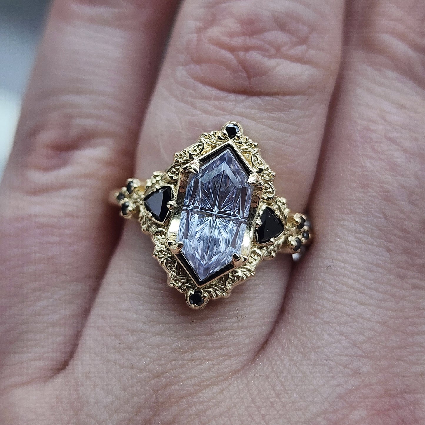 Ophelia/Delilah hybrid ring features a 2.92ct Light Purple Lab Sapphire Duchess Fantasy Cut from Fellowship Forge. The ring is accented with black diamond trillions totaling .18cts and additional black diamond accent stones totaling .07cts Crafted in 14kt yellow gold image 10