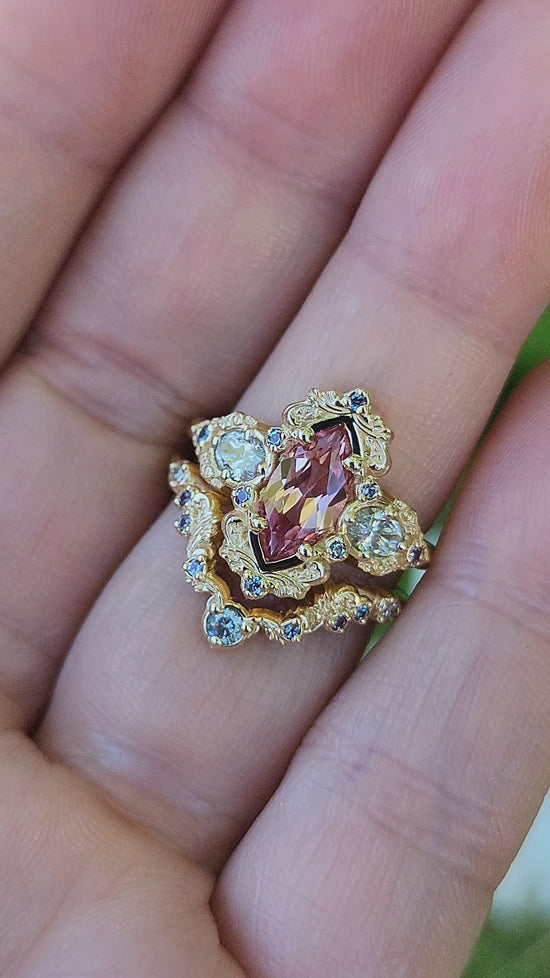 Load and play video in Gallery viewer, Chatham Peachy Pink Champagne Sapphire Josephine Engagement Ring Set with Oval Side Stones 14k Yellow Gold with color change Alexandrite Accents unique fairytale ring video 2

