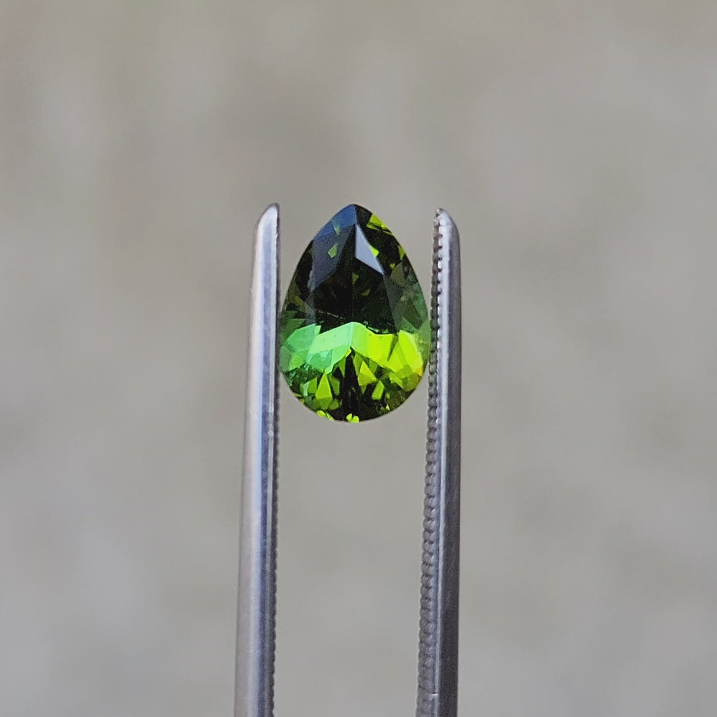 Load and play video in Gallery viewer, 1.03ct Natural Dichroic Green Tourmaline Pear- 7.7x5.5mm
