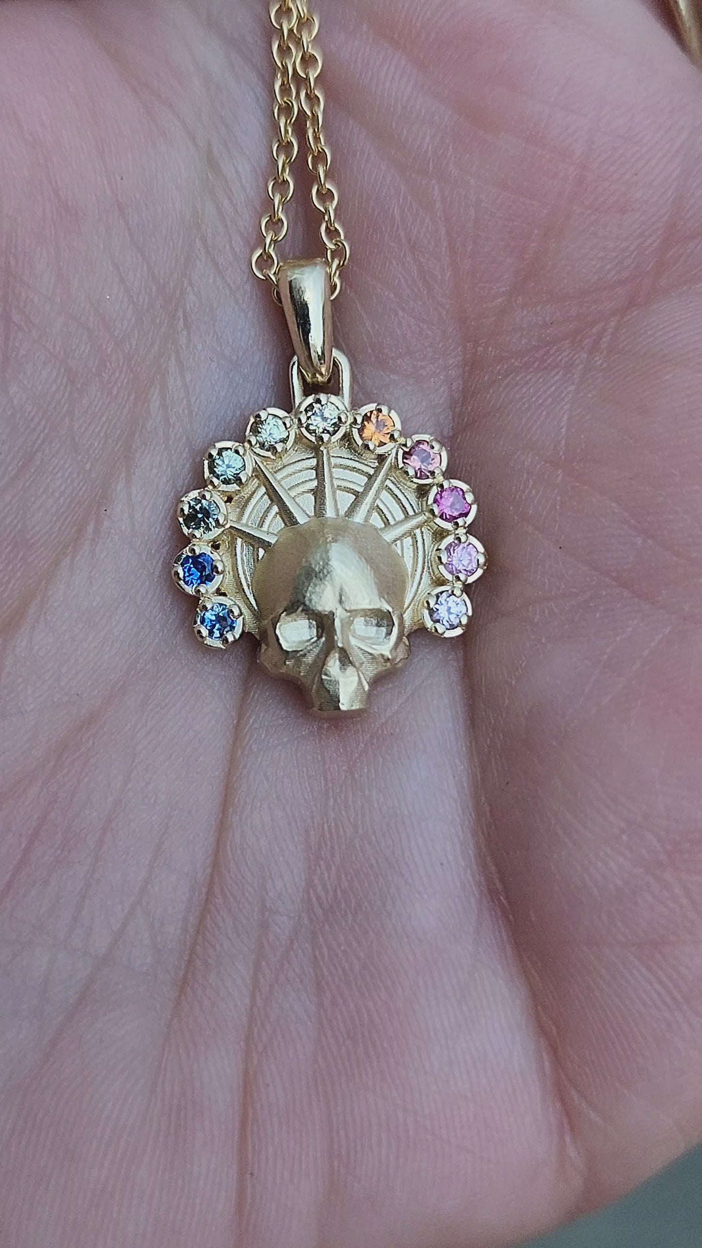 Load and play video in Gallery viewer, Rainbow Aura Angel Pendant - Catacomb Memento Mori Gold Skull Necklace with Natural Sapphires - Gothic Fine Jewelry
