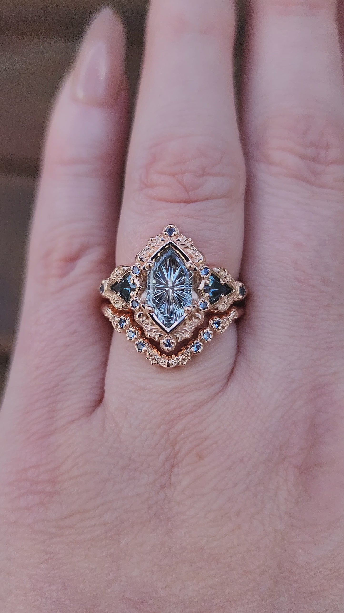 Load and play video in Gallery viewer, Fantasy Cut Montana Sapphire Odessa Art Deco Engagement Ring with Sapphire Kite Side Stones and Delicate Gold Scrolls - 14k Rose Gold video

