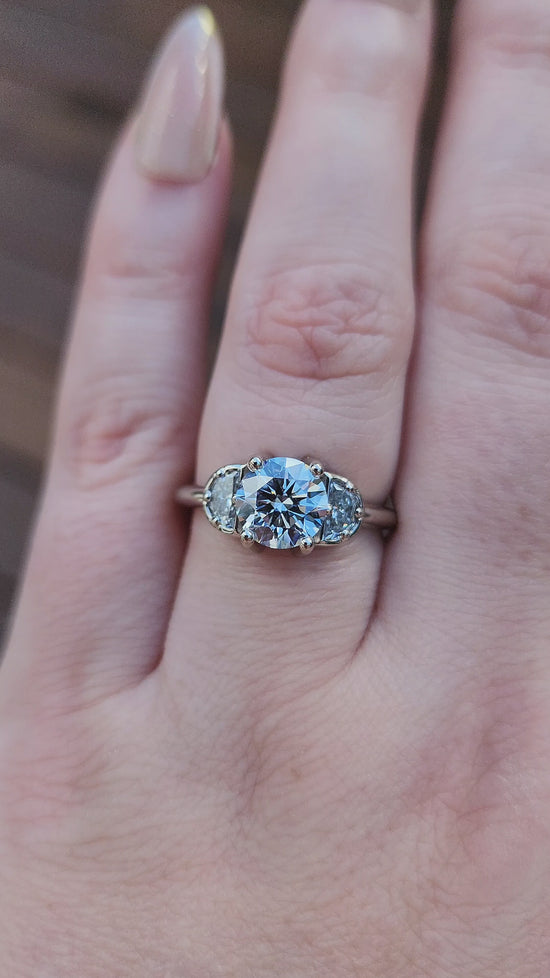 Load and play video in Gallery viewer, Diana 1.51ct Faint Blue Round Brilliant Diamond 3 Stone Half Moon Engagement Ring - 14k Palladium White Gold video
