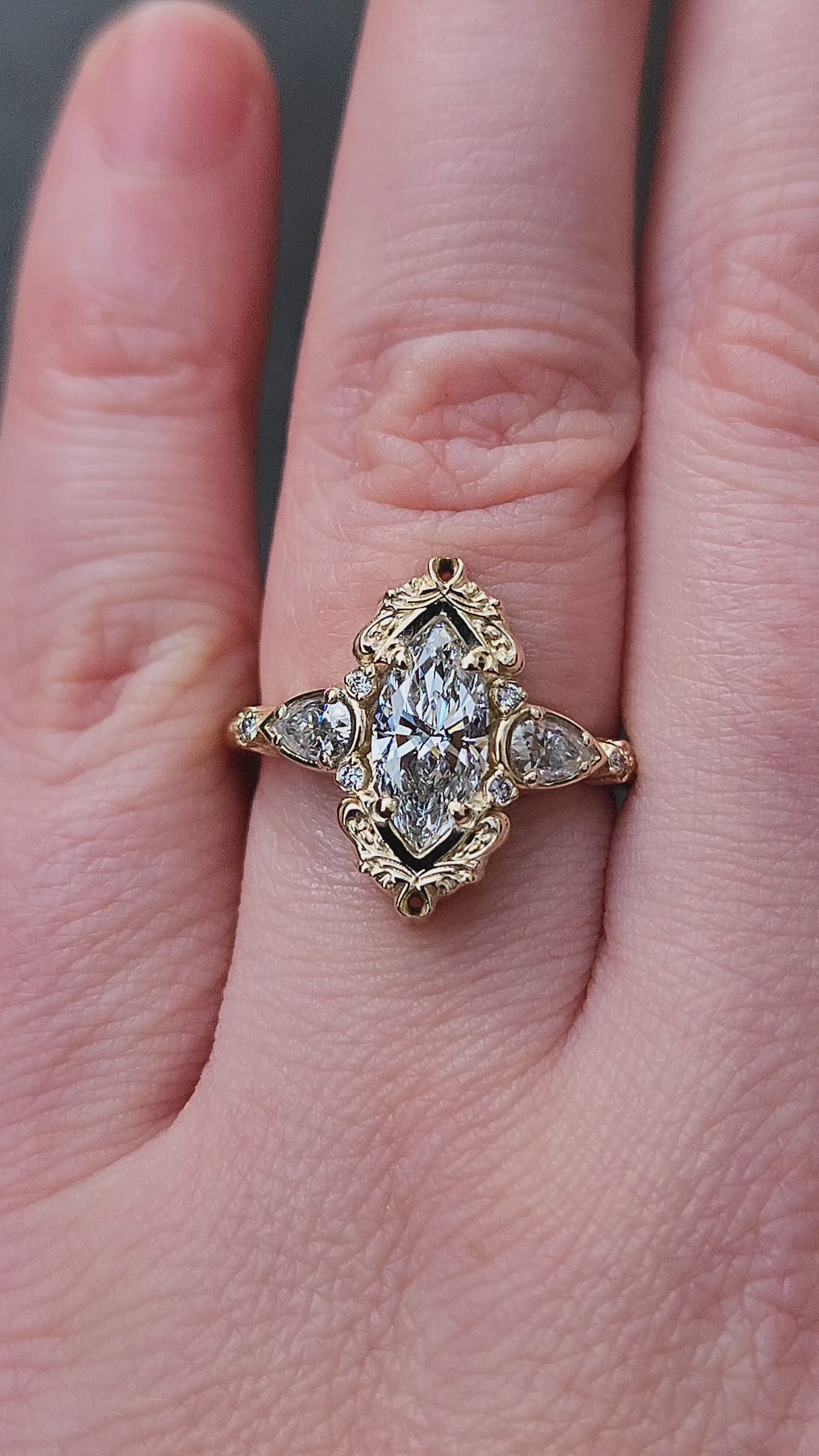 Load and play video in Gallery viewer, Large Lab Diamond Odette Marquise Engagement Ring with Pear Side Stones and Gold Scrollwork - Fantasy Filigree 14k Gold Handmade Ring
