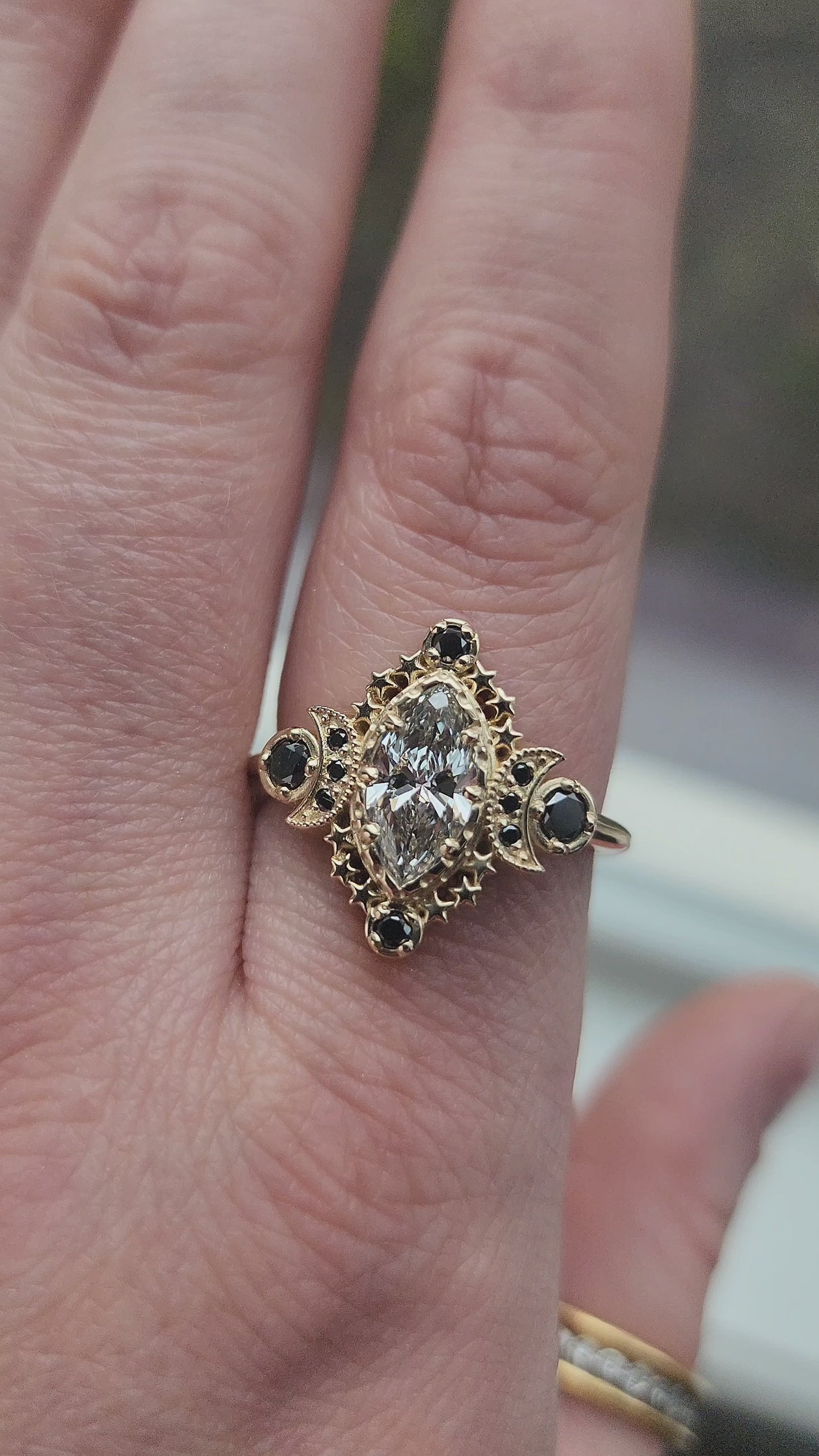 Load and play video in Gallery viewer, Cosmos Ring features a stunning 1.03ct Lab Marquise Diamond (with report) set in 14kt yellow gold The center stones is beautifully encircled by .40ct black diamonds video 1
