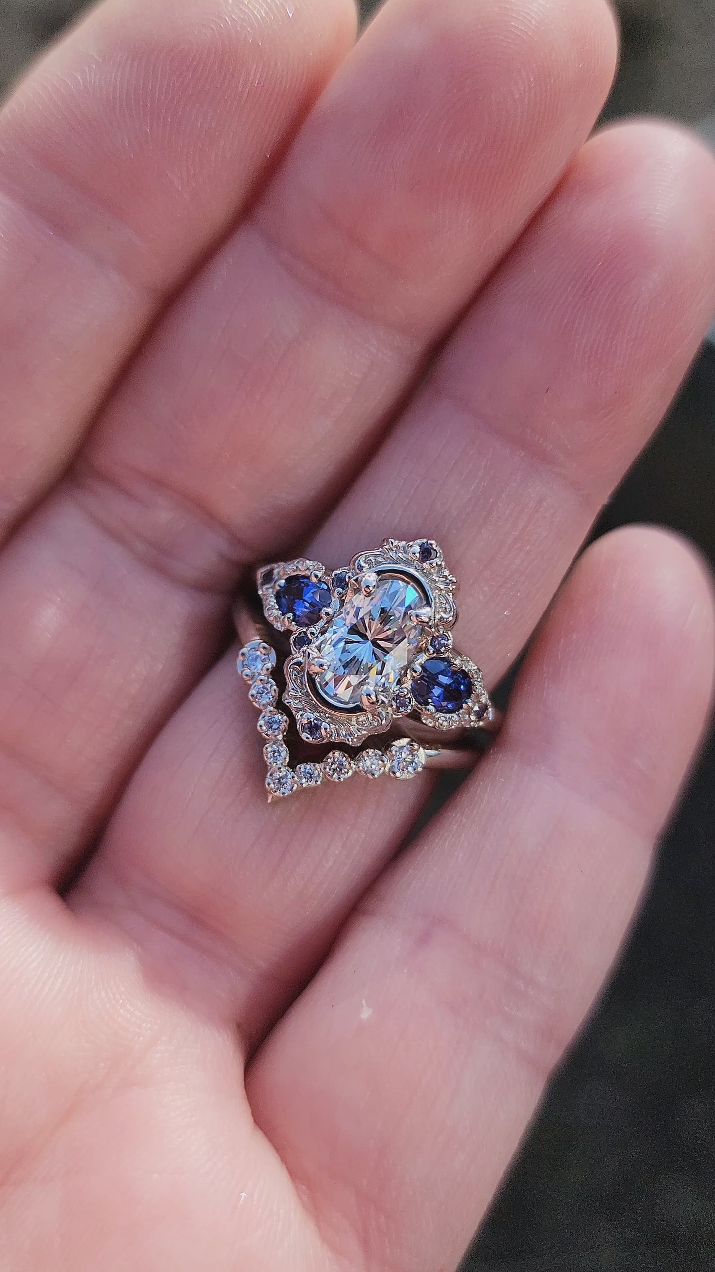 Load and play video in Gallery viewer, Josephine Set with a 1.10ct Elongated Oval Moissanite and Lab Blue Oval Sapphire Sides video
