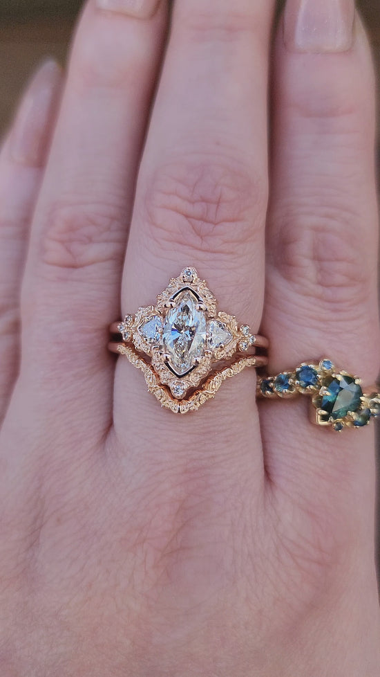 Load and play video in Gallery viewer, 1.06ct Marquise Lab Diamond Delilah Engagement Ring with Trillion Side Stones and Wedding Band - 14k Rose Gold video
