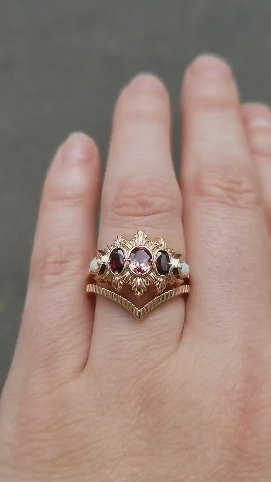Load and play video in Gallery viewer, Ready to Ship Size 6 - 8 - Champagne + Rhodolite Oval Garnet Moonfire Engagement Ring Set - Lab Opals &amp;amp; Chevron Wedding Band - 14k Rose Gold
